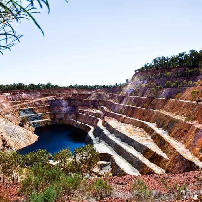 The historic gold mine at Peak Hill operated between 1893 and 1917, producing about 60,000 ounces from 500,000 tonnes of rock. Alkane excavated for gold on the site between 1996 and 2002, retrieving 145,000 ounces from 4.9 million tonnes. While much of the historic operations were consumed by the recent mining activity, Alkane has managed to preserve some of the old workings. The Open Cut Experience includes both the historical works and the more recent mines, with self-guided walking paths constructed. The Open Cut Experience offers a rich tourism experience, with visitors able to access viewing areas over five open cuts, spectacular views from the hilltop, walking trails, rest areas, and a bridge walk over historic mine workings.